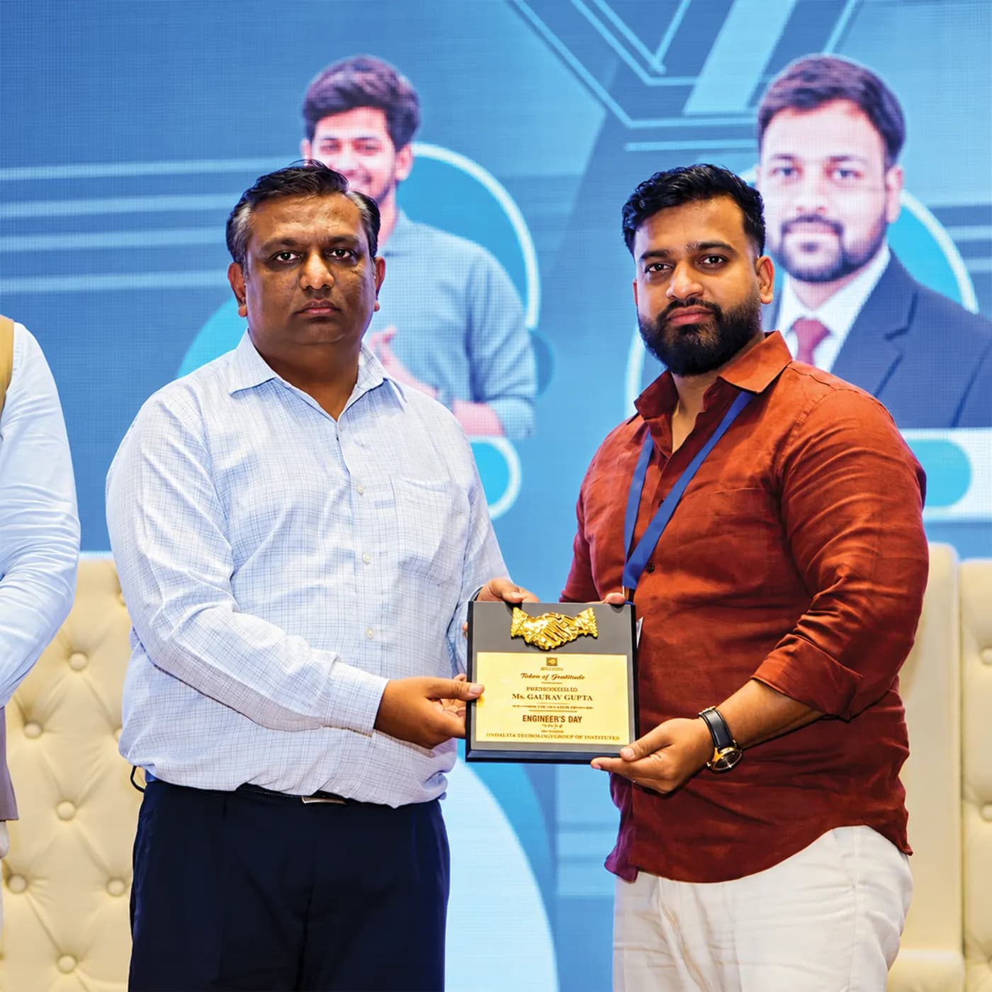 A techcadd team member receiving an award on stage