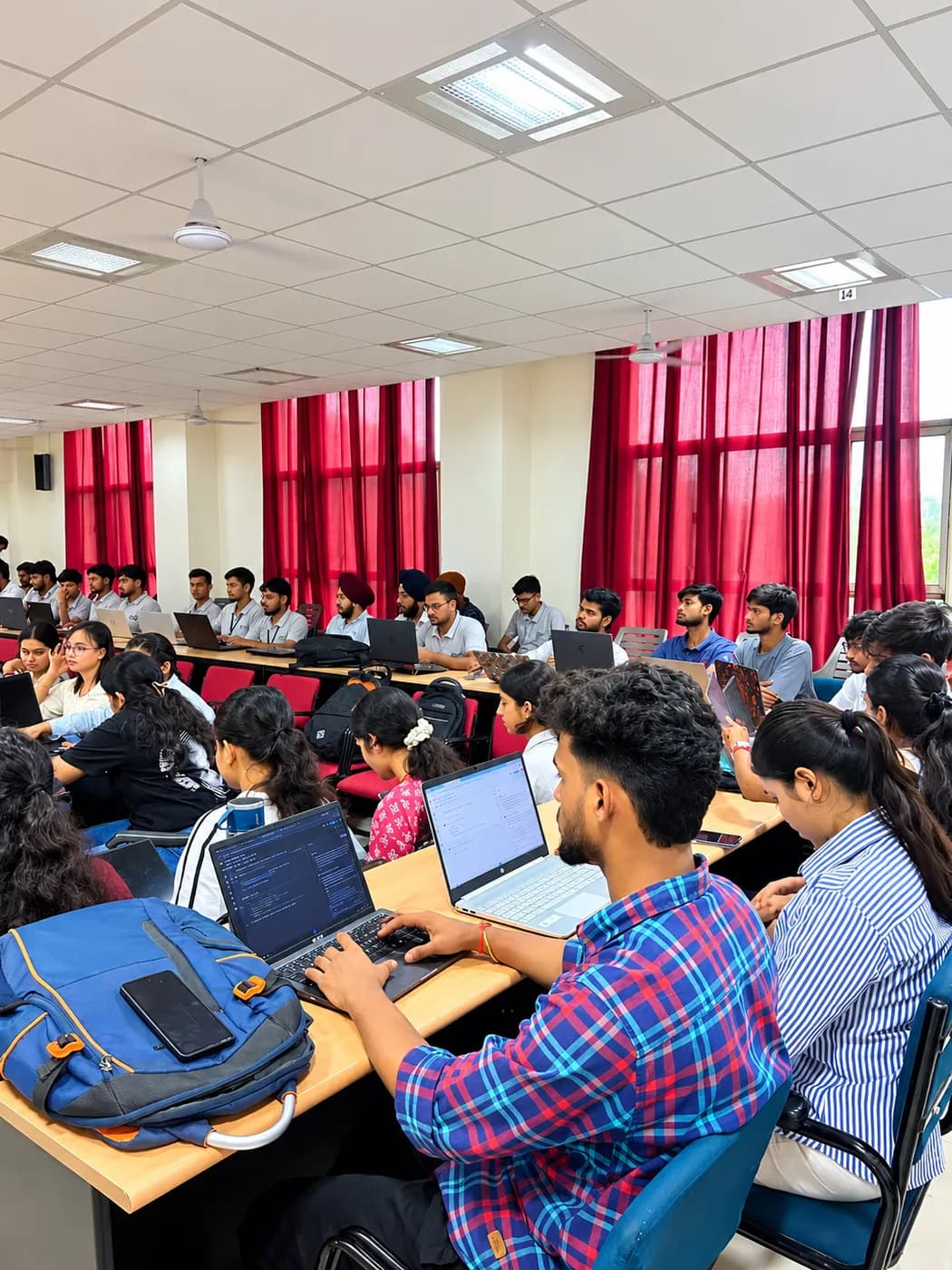 Students on laptops at a techcadd college workshop