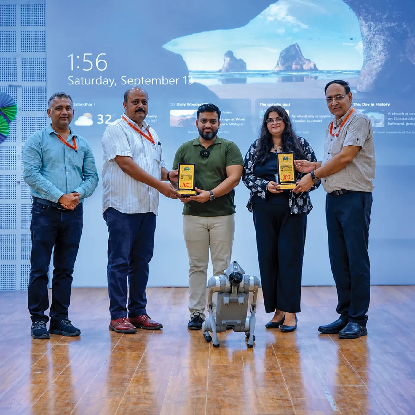 techcadd team honoured on stage beside the robot dog