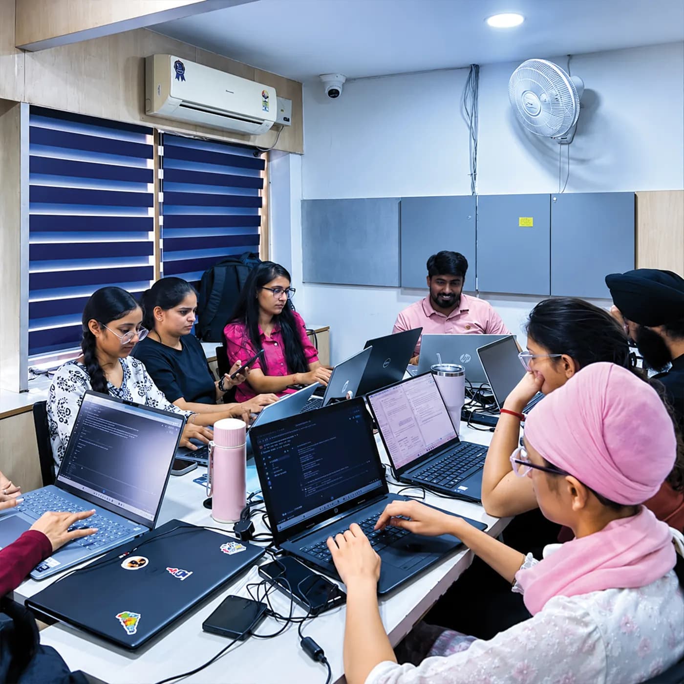 Students working on projects around a table