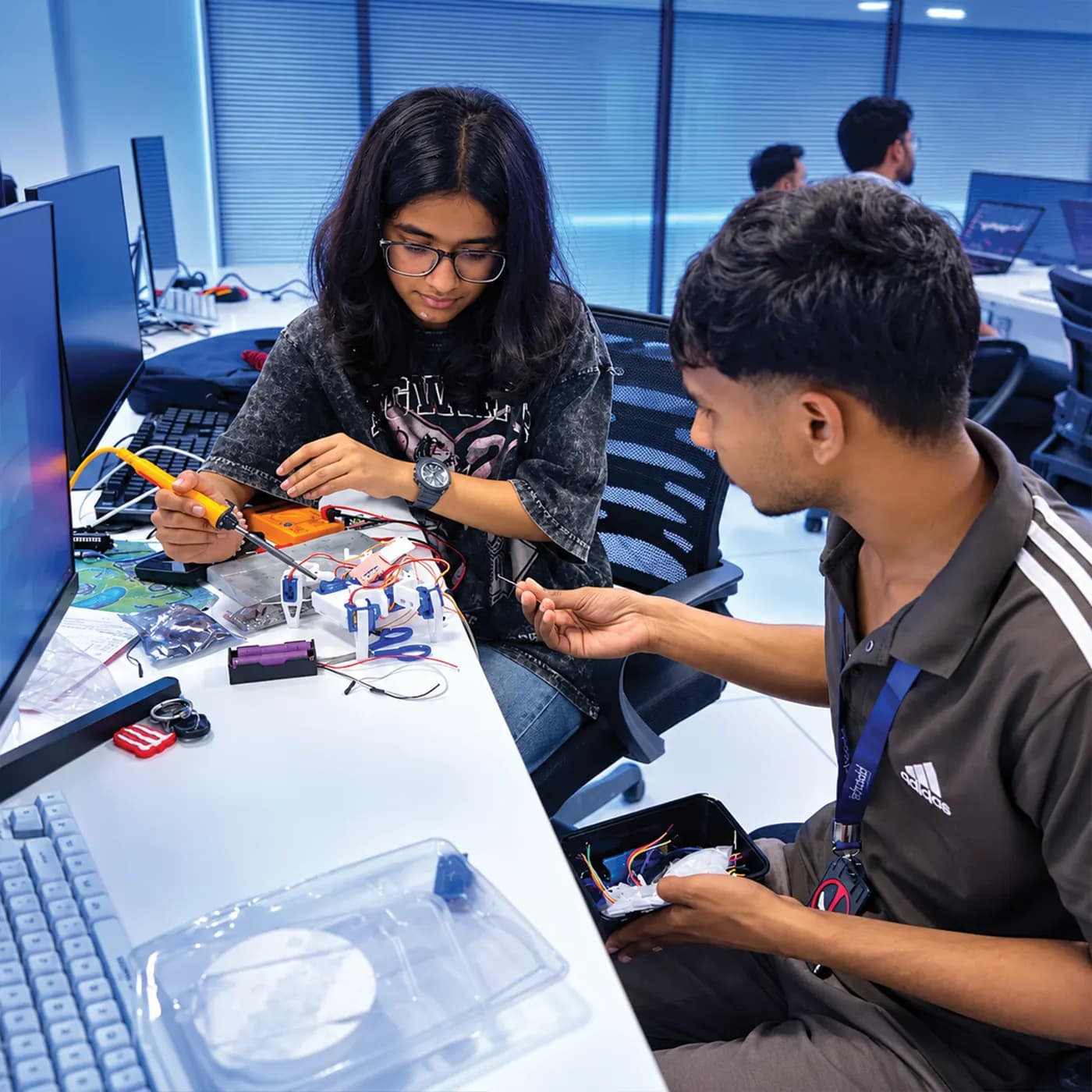 Students working with electronics and robotics kits