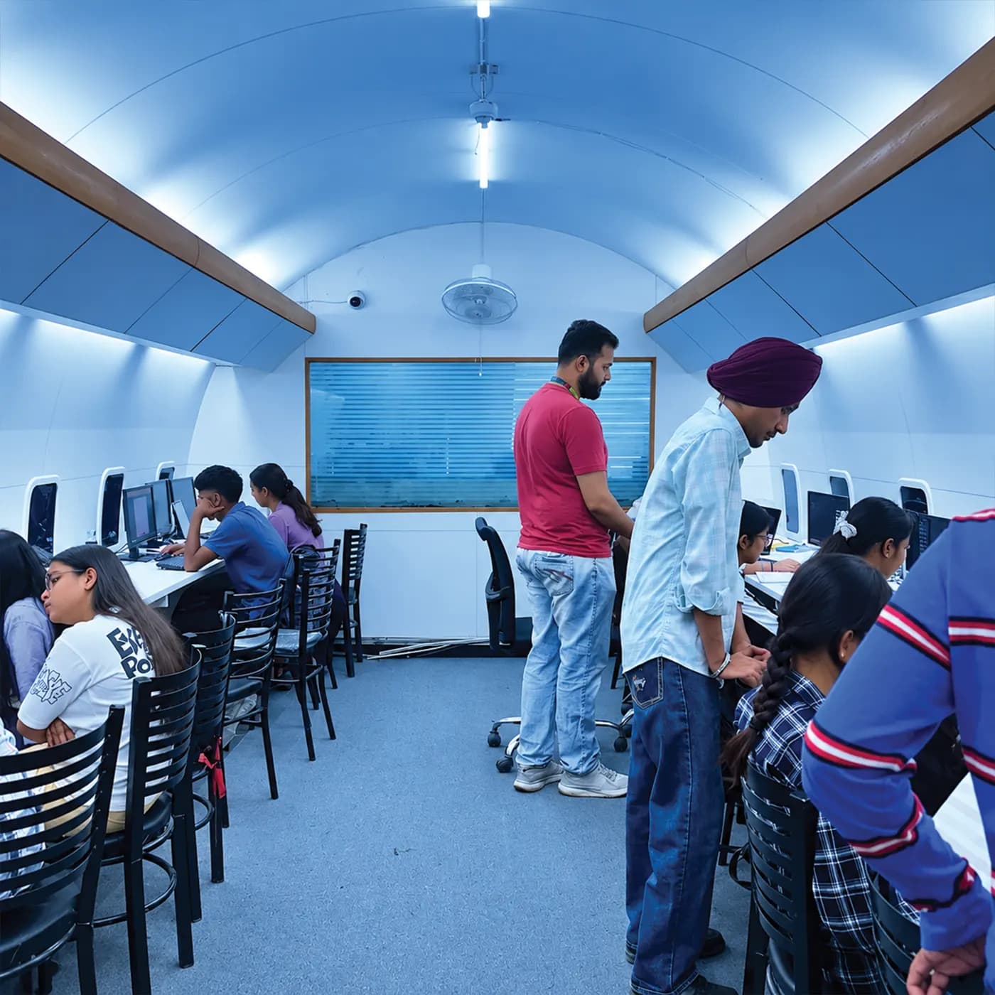 Trainers guiding students in the aircraft-cabin computer lab