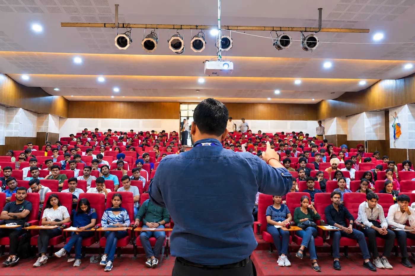 A techcadd speaker addressing a full auditorium